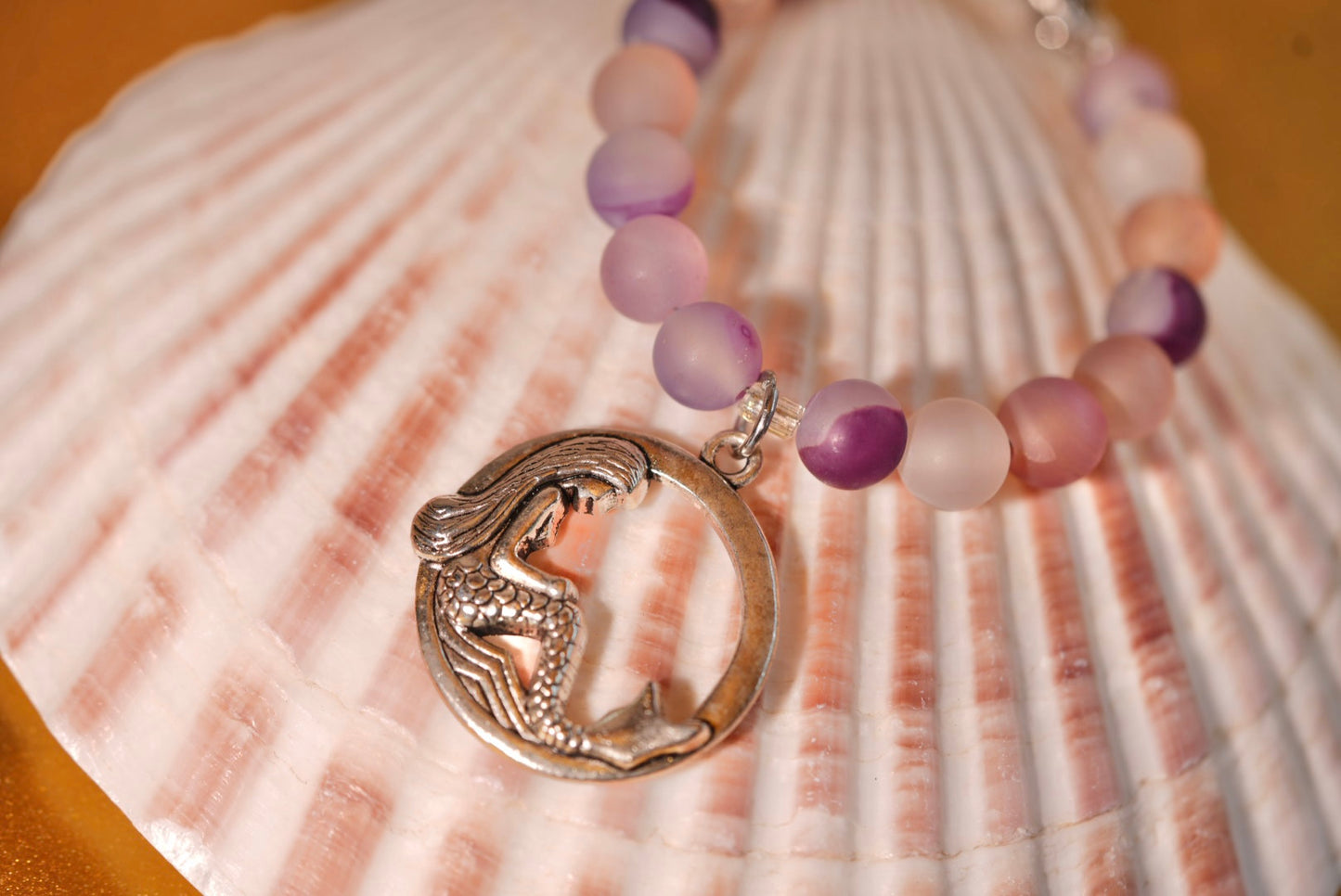 Necklace with mermaid pendant on a seashell
