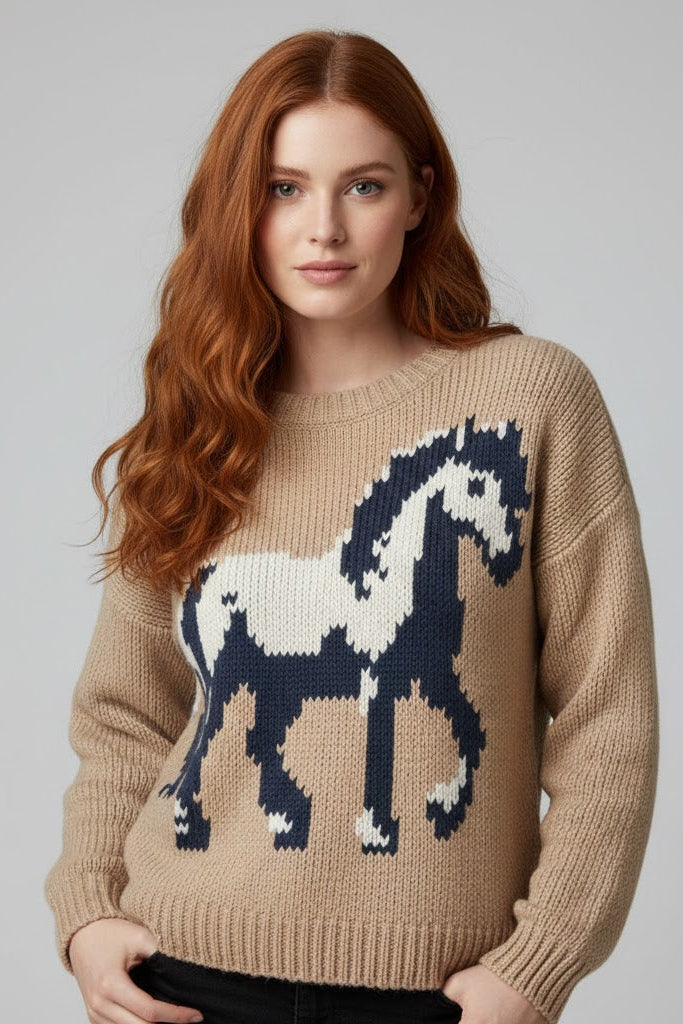 Woman wearing a beige sweater with a horse design on a gray background